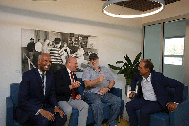 Ministers Hussen and Boissonnault and Mayor Sohi visit with a resident of Grace Village.