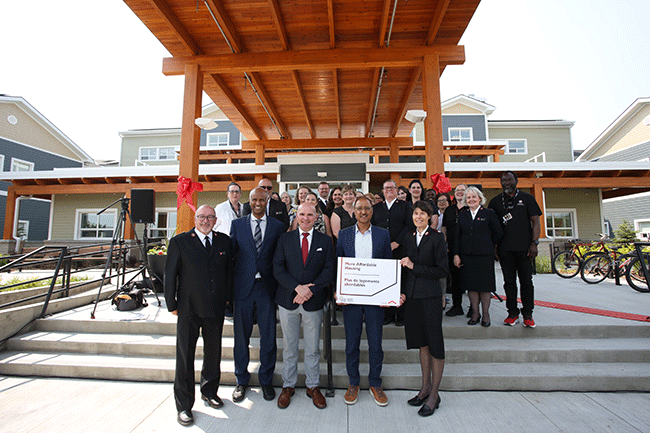Staff of The Salvation Army and speakers celebrate the announcement of more than $38 million in funding for 175 homes and beds at Grace Village.